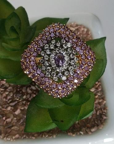 Golden ring with light purple diamond